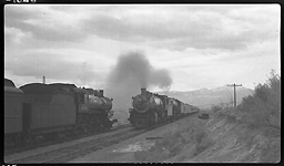 NP 1758, Class W-3 and NP 2611, Class A pulling Train No. 1 and meeting NP 2130, Class Q-1 with Train No. 236 a Pipestone, MT