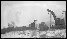 NP Wrecker 23 is rerailing a tank car from derailment of 19 cars from Train No. 603 at Turah, MT, MP 109.6, between Clinton and Bonner, MT