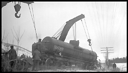 Two wreckers picking up CONX 2631 which derailed in derailment of 19 cars from Train No. 603 at Turah, MT, MP 109.6, between Clinton and Bonner, MT