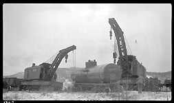 Two wreckers working on pick up of tank car from derailment of 19 cars from Train No. 603 at Turah, MT, MP 109.6, between Clinton and Bonner, MT