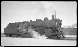 NP 1768, Class W-3, at Bozeman, with Bozeman roundhouse in background and snow on the ground.