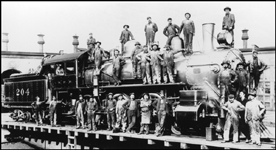 NP 204, 4-6-0 on turntable at Tacoma roundhouse with entire workforce posing around locomotive for this photograph.