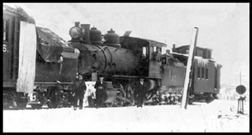NP 97  Wallace  About 1902  cy Beebe NP class F  2-8-0  [Baldwin, 1883] on what may be a snowplow train  Cropped equipment on the left may be a rotary snowplow  Engine later rebuilt into a class G  0-8-0 switch engine  Crew on ground unidentified