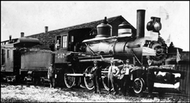 NP 547, formerly NP 727, Class D-3 at Edgeley, ND.  Crew members are posing in front of the locomotive which is decorated for a special occasion.