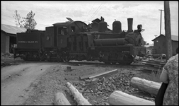 Diamond and Caldor 7  Diamond Springs Calif  1938  RWB  The identity of photographer RWB is unknown to the cataloger  This is probably a negative that Nixon obtained in trade  The locomotive is a Shay, characterized by vertical cylinders on the right side of the boiler  These cylinders transfer power to the small drivers via beveled gears and a long driveshaft  A Shay can negotiate very sharp curves, very rough track and very steep grades, making the design a favorite for logging railroads such as the Diamond and Caldor  The D&C is located on the western slope of the Sierra Mountains in the 