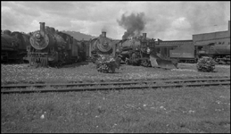 Miscellaneous engines  Spokane  4-30-41  The negative is from ILN, a photographer who's identity is unknown.  The engines are sitting on the garden tracks on the south side of the turntable at NP's Parkwater engine terminal.  The track in the foreground is part of the balloon track around the terminal, used for turning trains.  It also serves as the west leg of the wye that is used for turning engines.  Having such turning facilities outside of the terminal proper means much less congestion around the turntable, and saves considerable time and effort.  The hill visible in the background is 