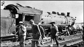 NP 2231, Class Q-5 on 1st No. 2, colliding with CB&Q 7008 at Billings.  Section workers pass in front of camera.  Engr. Graves on 2231.