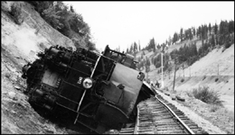 Front end view of overturned NP 5140, Class Z-8, derailed 2 miles east of St Regis with train X5140W J Mfst.  27 cars demolished. Derailment caused by broken 130 lb. rail.  Engr Vinson, Fmn C K Hale, Condr Wood.   