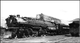 NP X5142W, with NP 5142, Class Z-8, leaving Missoula on its first trip, while passing Missoula Coal and Lumber Company. 