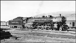 NP 2609, Class A in yards at Missoula with several outfit cars parked on nearby tracks.