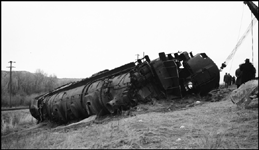 Second No. 3, an equipment special (deadheading Pullmans), derailed at 80 miles per hour on a 40 mile-per-hour curve, about a mile and a half east of Logan, Montana, on November 22, 1945, three days before this photo was taken. A new 250-ton wrecker has just begun the arduous task of dragging the nearly 500-ton Class Z-8 4-6-6-4, no. 5132, back toward the track.