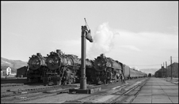 From left-to-right, NP 4-8-4s, Class A-5 no. 2685, Class A-3 no. 2663, and 2nd No. 1, powered by Class A-5 no. 2687. Helper engine no. 1842, a Class W-5 2-8-2, appears in the right background. This photograph was made at Livingston, Montana, as engines were being changed on the First and Second Sections of No. 1, the westbound North Coast Limited.
