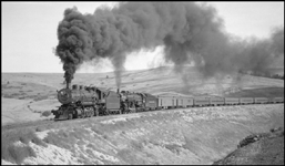 Train No. 1 pulled by NP 1539, Class W, with Engr. Dickman and NP 2607, Class A, with Engr. Jeffery on O'Keefe fill between DeSmet and Evaro