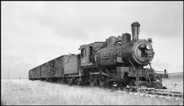 WSS&YP No. 42, 4-4-0, ex. MILW 42, ex. CMSP&P 904, a Rogers built, number plate 6232, locomotive pulling stock cars between Ringling and White Sulfur Springs, MT. 