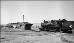 An American Standard, ready for the road, and a combine coach with no more places to go, are together at the outer end of a small railroad with a big name.  White Sulphur Springs and Yellowstone Park?surely a grand name for a 20 mile railroad.