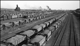 Duluth Minnesota and Iron Range RR Yard in Proctor, MN with lots of loaded ore cars full of iron ore. Coal dock in background.