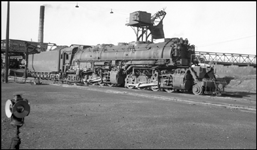 DM&IR 232, 2-8-8-4 takes water at Proctor, MN.  Mechanic making adjustments.