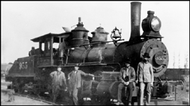 NP 955, Class K-1 surrounded by crew posing for camera in front of locomotive.