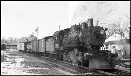 This is a mixed train on the Taylors Falls branch line.  The combination baggage/passenger/mail car has been cut off the train in order to switch one or more of the freight cars.  The class S-10 328 was part of a group of locomotives built for another railroad, and purchased by NP when that railroad defaulted on the order.  The 328 was saved after dieselization, and for many years pulled excursion trains in northern Minnesota.  In 2006 it may be found in the Jackson Street Roundhouse in Minneapolis awaiting rebuilding.