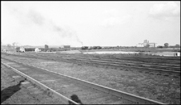 Panorama of Council Bluffs, IA, yard, with diesel switcher and freight in distance.