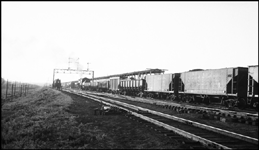 Going away shot of UP Extra 2314 West, eng. 2314, and gondolas, passing ice house, Council Bluffs, IA.