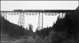 NP 1811, Class W-3, 2-8-2, with three diesel helpers Train #1, NCL, Crossing Marent Trestle, MT.