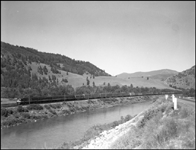 NP 7000, EMD F-9A with east bound extra freight along the Clark Fork River at Bearmouth, MT