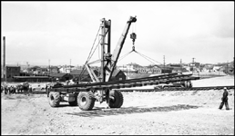 Moving panel rail for use in building railroad to move NP 25 at Butte, with huge crowd watching operation.