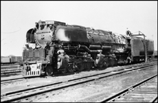 Smoke deflectored UP 4-6-6-4 Challenger no. 3977 taking oil in North Platte, NE, yard.