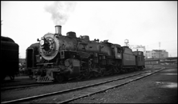 Slightly blurred shot of NP Class W-3 2-8-2 Mikado no. 1801 and caboose in Hoyt St. yard, Portland.