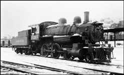 Minus its headlight, derelict Copper Range 2-6-0 Mogul no. 58 sits in snow at Duluth Union Station.