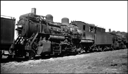 Another displaced locomotive, an Alco 2-8-0, waits for sale or higher scrap prices, in a cornmer of the Spokane yard.  Some engines spent many years in dead storage in the Fifties.