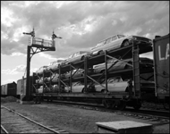 Automobile traffic by rail was rare in 1961.  But a new design, carrying new cars on three layer flatbeds rather than shoehorned into boxcars would soon recapture much new auto traffic.  Here si one of the first auto rack loads over the Northern Pacific