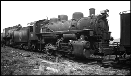 Many smaller railroads took advantage of a bargain at the end of World War 2, the availability of many military surplus switch engines, new and hardly used, at a very low price.  Some, like this engine on a Spokane scrapline, had a very short civilian career. It was built by Alco in 1942 and retired after seven years of military and civilian service.