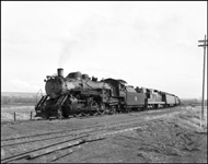 CBQ 4960, a 2-8-2 steam locomotive and a diesel helper with passenger cars east of Silesia, MT.