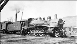 NP Class Y-1 2-8-0 Consolidation no. 25, engineer perched in the cab window, switches passenger cars at Missoula.