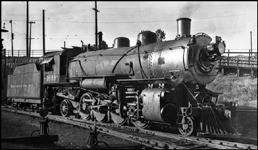 Saint Paul Division local freight engine 1608 is on the north side of town, heading for White Bear Lake and Rush City and Carlton.  The 1906 Alco Mikado is one part of a fleet on 160 such engines.