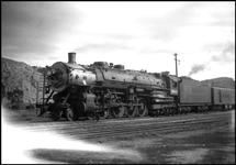 An A 4-8-4 pauses at the junction station at Logan to allow passengers to make connections for alternate routes.  This engine was part of the first order of Northerns built, built at ALCO in 1927.