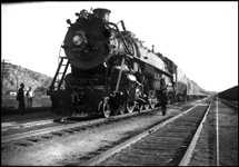 Logan has one of its more exciting moments as the westbound North Coast Limited makes its scheduled pause and transfer connecting passengers to the Helena train.  The power is one of NP's 10 A-2 Northerns, built by Baldwin in 1934.