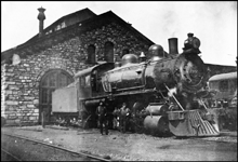 NP 1387, a class S-4 ten-wheeler, and its engine crew pose outside a stone masons marvel of a roundhouse.  1397 is configured as a Vauclain compound, but was simpled and superheated in the early 1920s.   Note the wrecking crane behind the engine