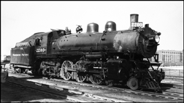 A Baldwin Q-4 Pacific, class of '09, is back from a Memorial Day visit to International Falls and headed for the roundhouse at Saint Paul Union Depot