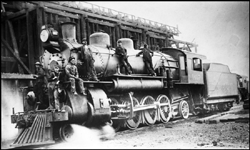 NP 1617, Class W locomotive at coal dock in Pasco with roundhouse service people posing for photograph.  According to Schrenk and Frey, this locomotive was later renumbered to 1917.