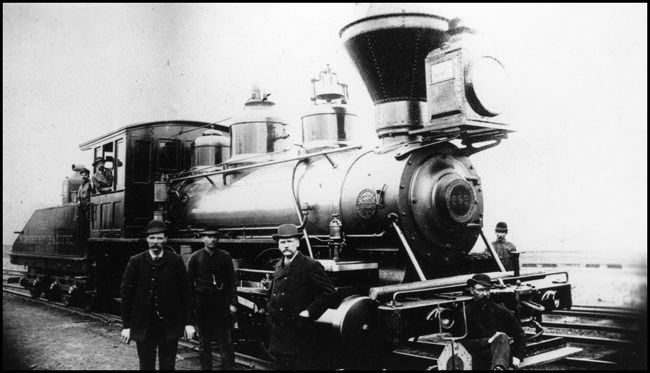 NP 399, 0-6-0 switcher, at Minneapolis, MN.  The five crewmen in the picture one in engine cab window, second in cab walkway, and the other three two in suits standing in front of the engine.  This enigne was later renumbered 998.