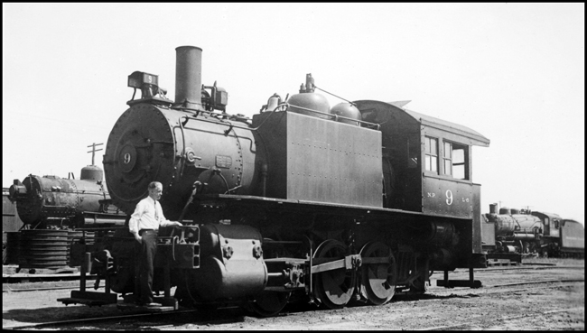 NP 9, a 0-6-0 tank switcher at South Tacoma, WA with a person with a tie standing on front pilot.