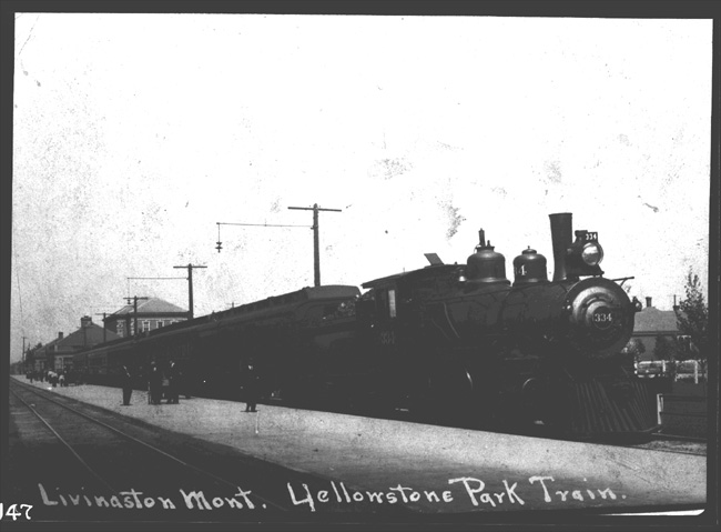 NP 334, Class E-3 coupled to Yellowstone Park train on Park train stub track in Livingston