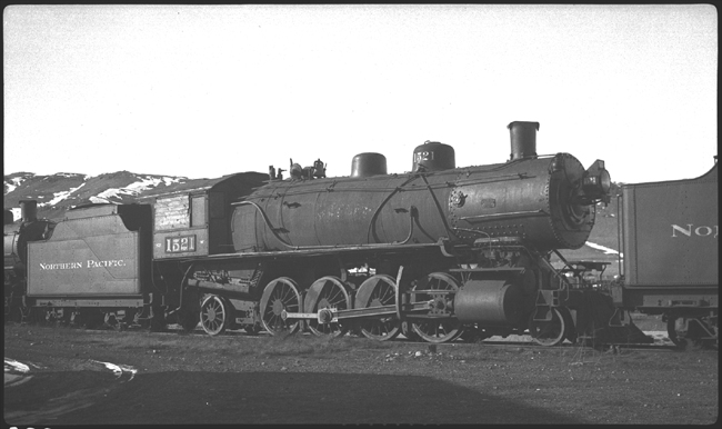NP 1521, Class W on storage track with windows boarded up, with other locomotives 