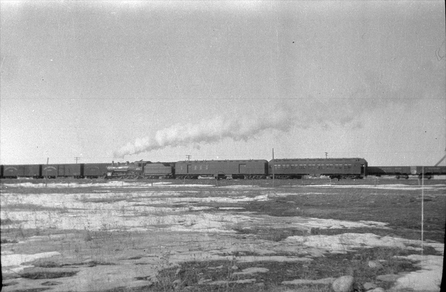 NP 250, Class P pulling NP train No. 205 past freight cars at Roberts