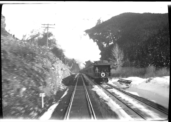 The rear of NP Train No. 2, the eastbound North Coast Limited, heading east from Bozeman near Mount Ellis at MP 134, as seen from rear of NP train No. 219, the westbound Billings to Butte passenger train. 