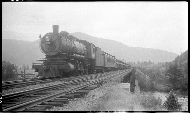NP 1565, Class W with Circus Special west on Missoula River bridge near Bonner, MT