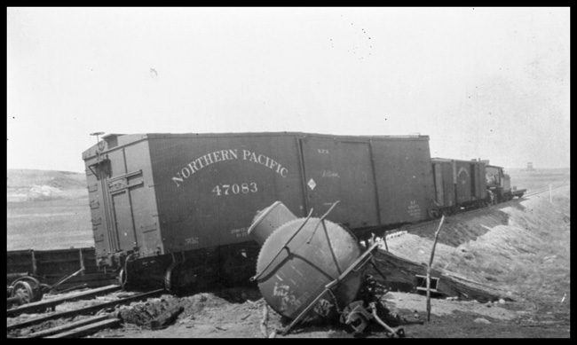 Train wreck near Dodge, ND.  One box car in picture is NP47083. 